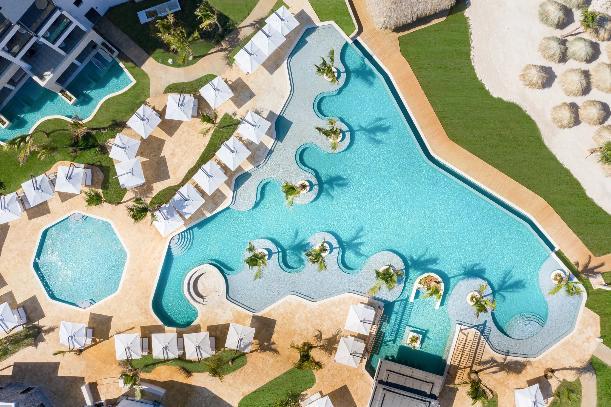 Aerial view of the infinity pool and beachfront at Dreams Macao Beach Punta Cana in the Dominican Republic.