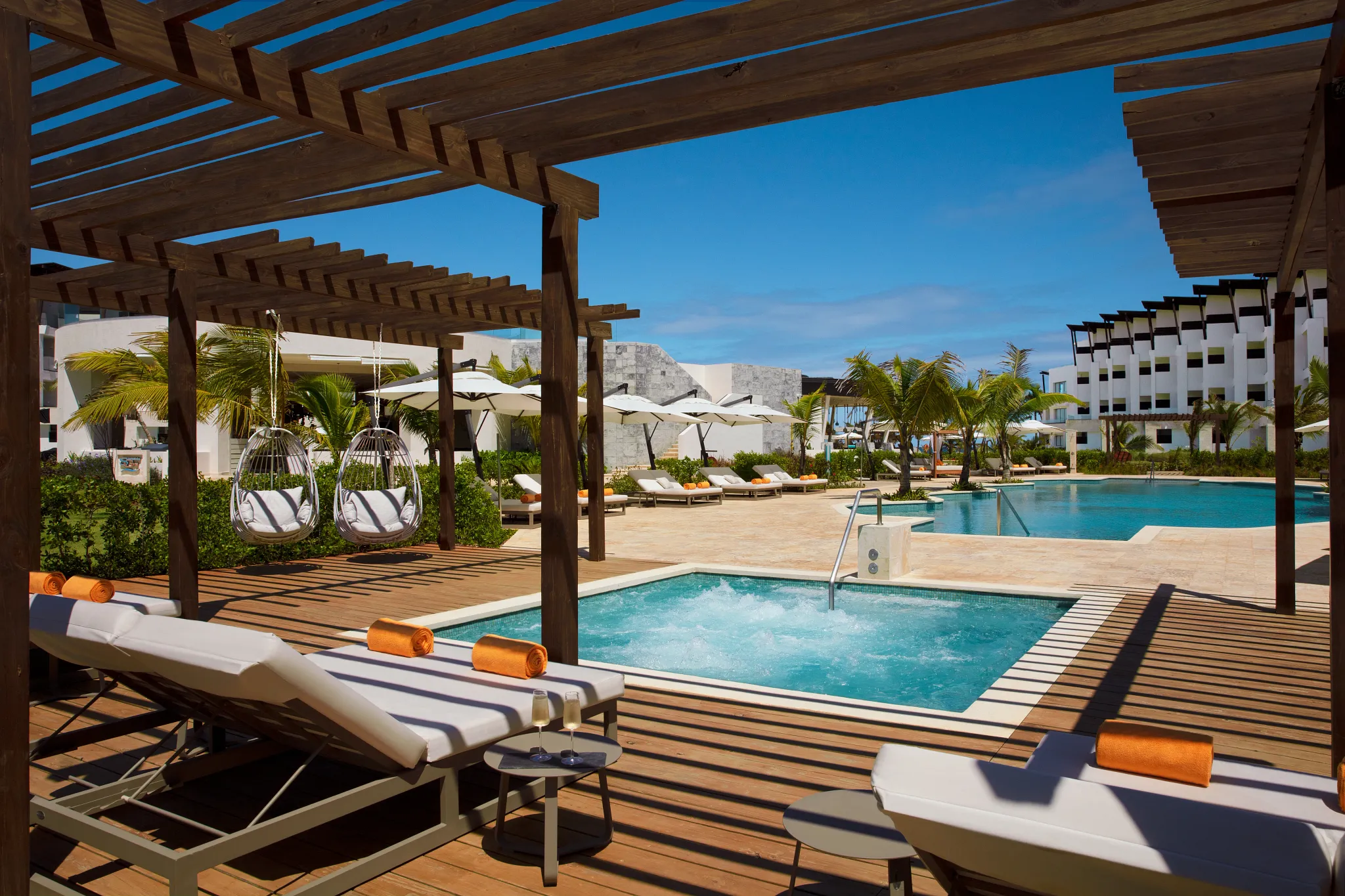 Overhead aerial view of the tropical resort pool at Dreams Macao Beach Punta Cana with palm islands and loungers.