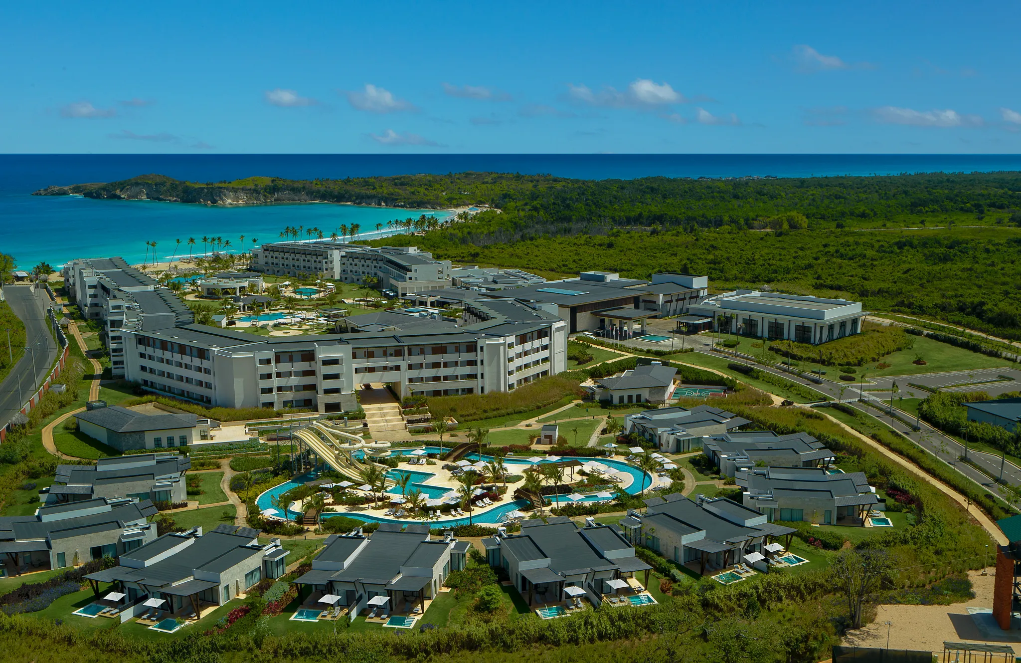 Aerial view of Dreams Macao Beach Punta Cana with beachfront pools, villas, and tropical Caribbean coastline.
