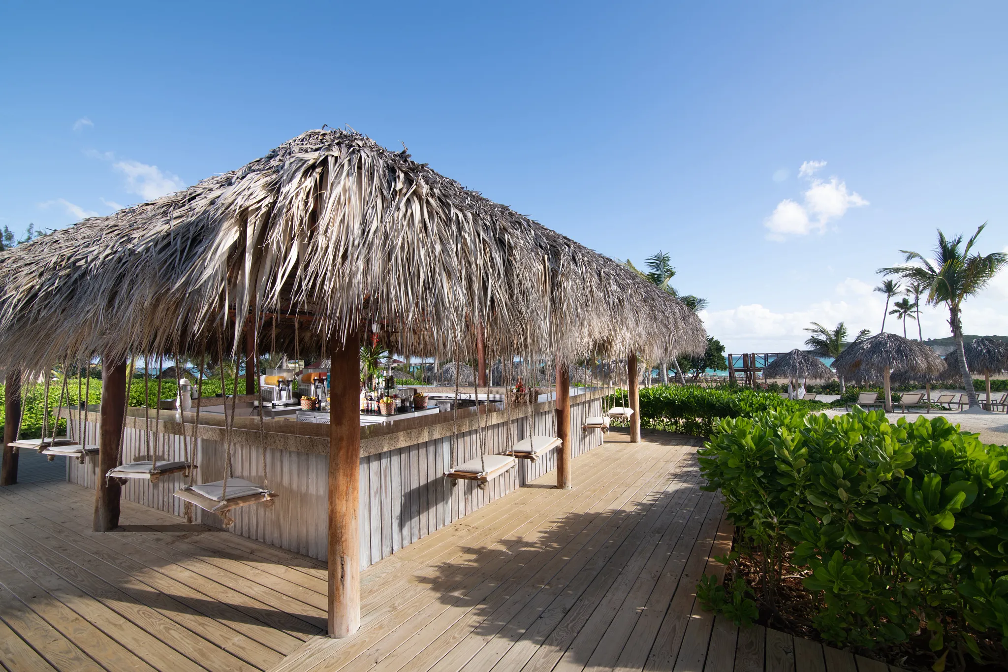 Barracuda bar at Dreams Macao Beach Punta Cana featuring tropical cocktails, stylish outdoor seating, and relaxed Caribbean resort ambiance.