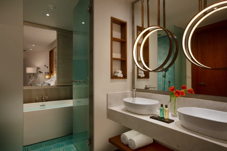Junior Suite Ocean View bathroom with dual vessel sinks and modern rain shower at Dreams Macao Beach Punta Cana.