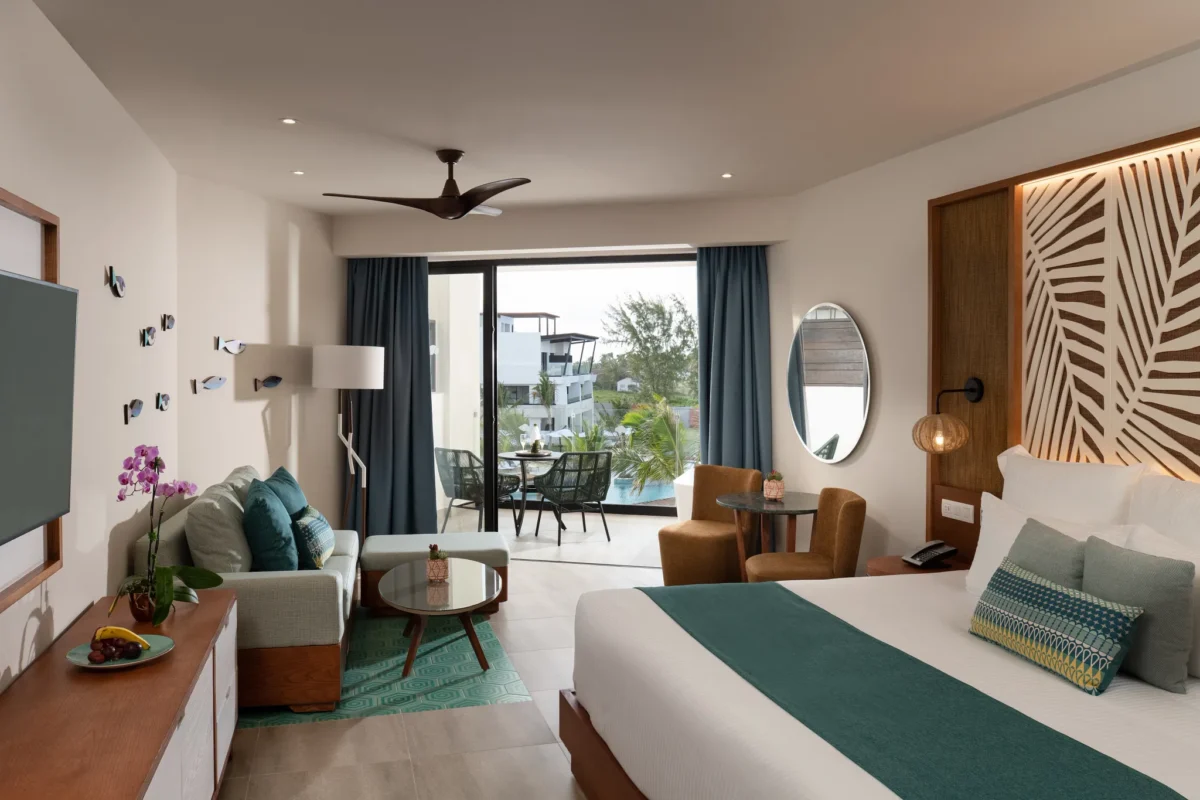 Junior Suite Pool View with king bed and living area at Dreams Macao Beach Punta Cana Resort.