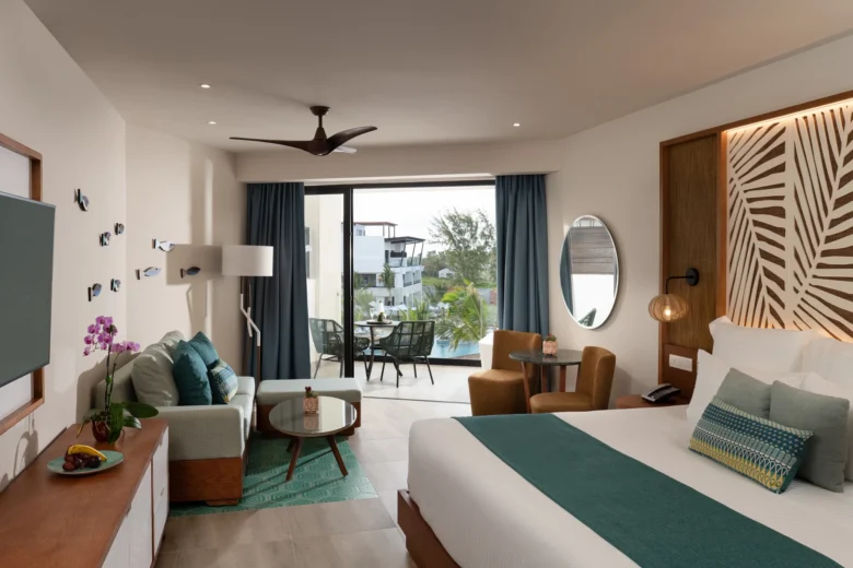Junior Suite Pool View with king bed and living area at Dreams Macao Beach Punta Cana Resort.