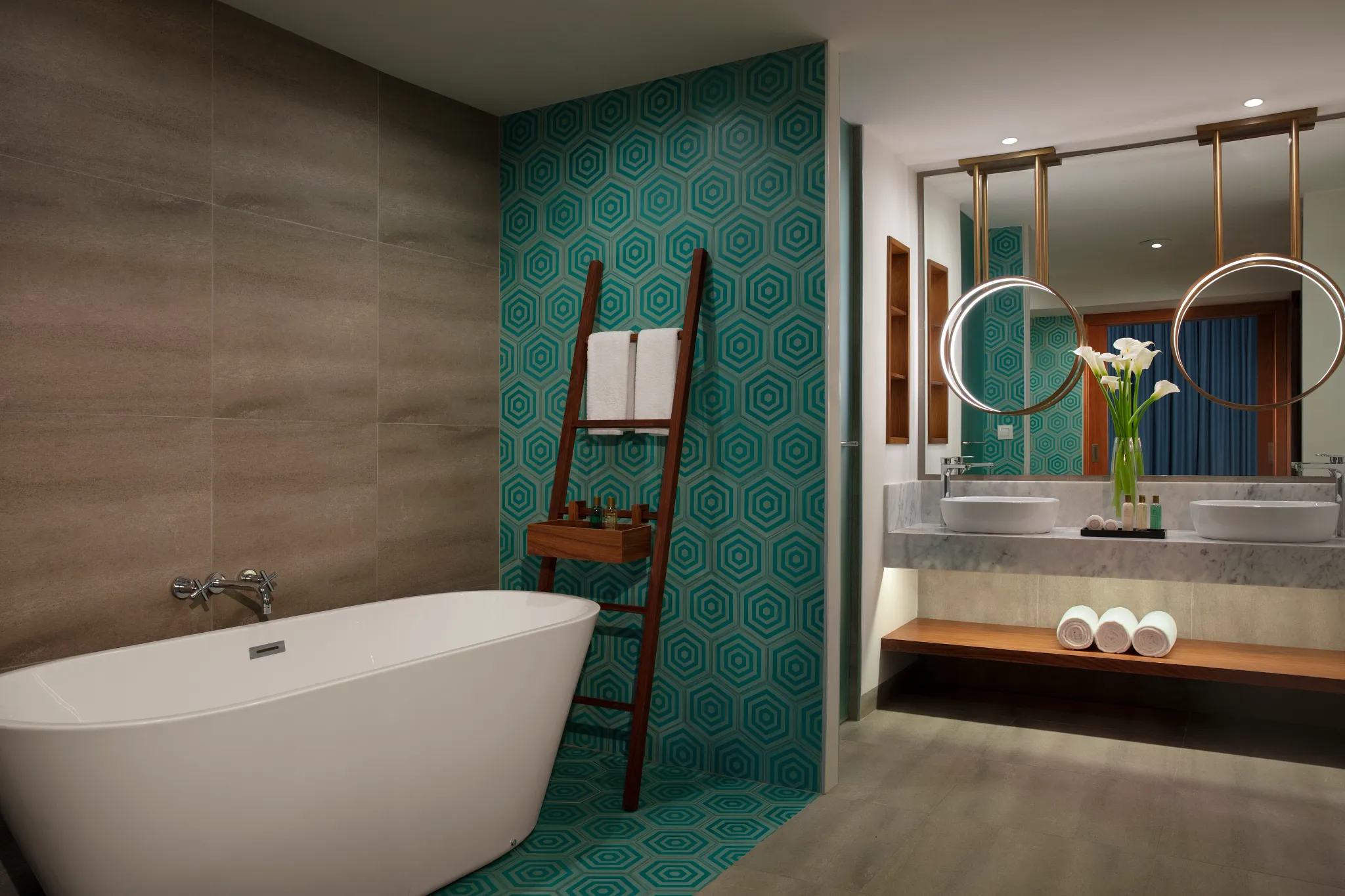 This Preferred Club Two-Bedroom Villa with Pool offers a spacious guest bedroom with two queen-size beds, contemporary Caribbean décor, and large windows overlooking the tropical resort gardens.
