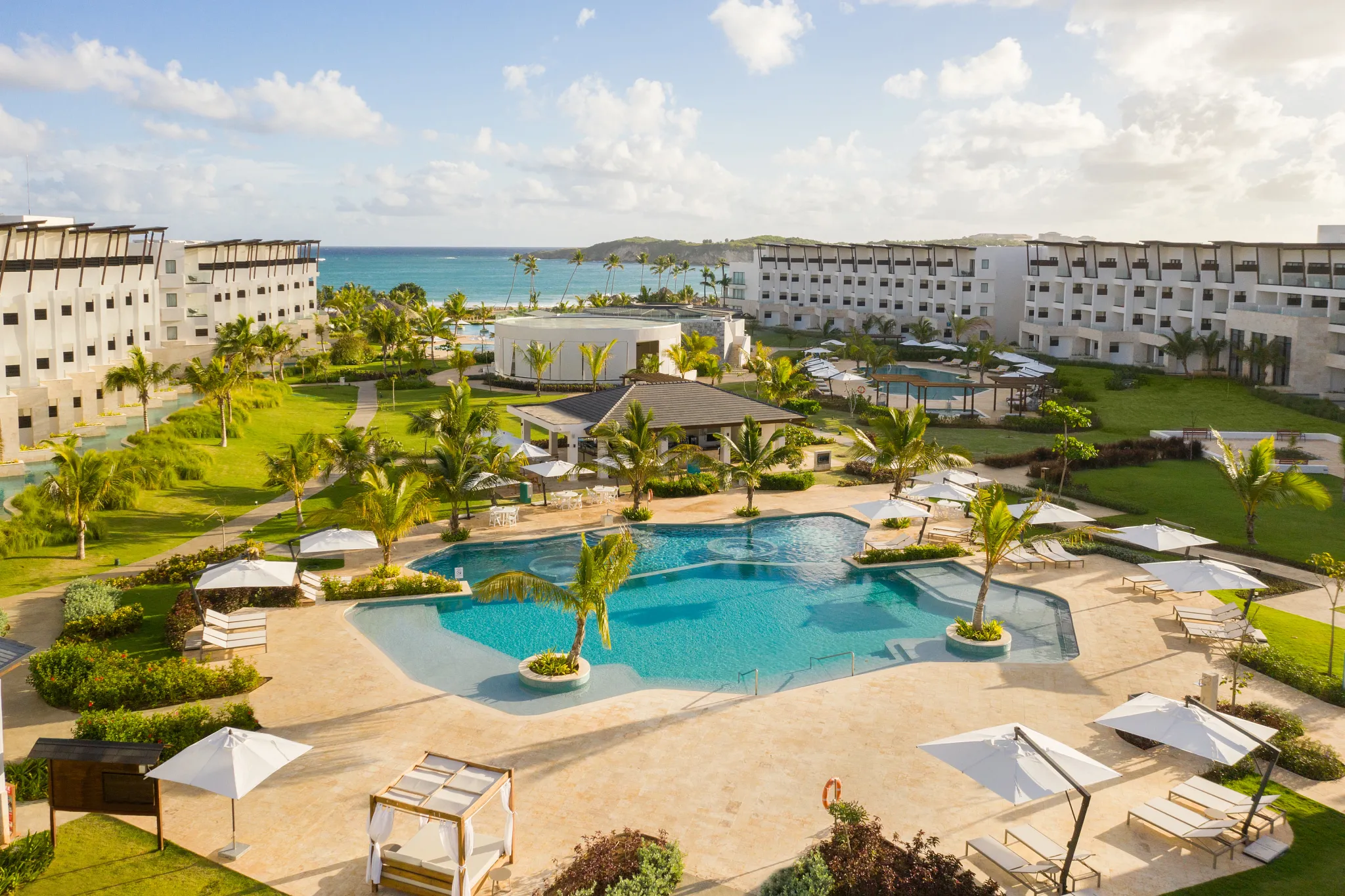 Relaxation pool surrounded by tropical landscaping and ocean views at Dreams Macao Beach Punta Cana.