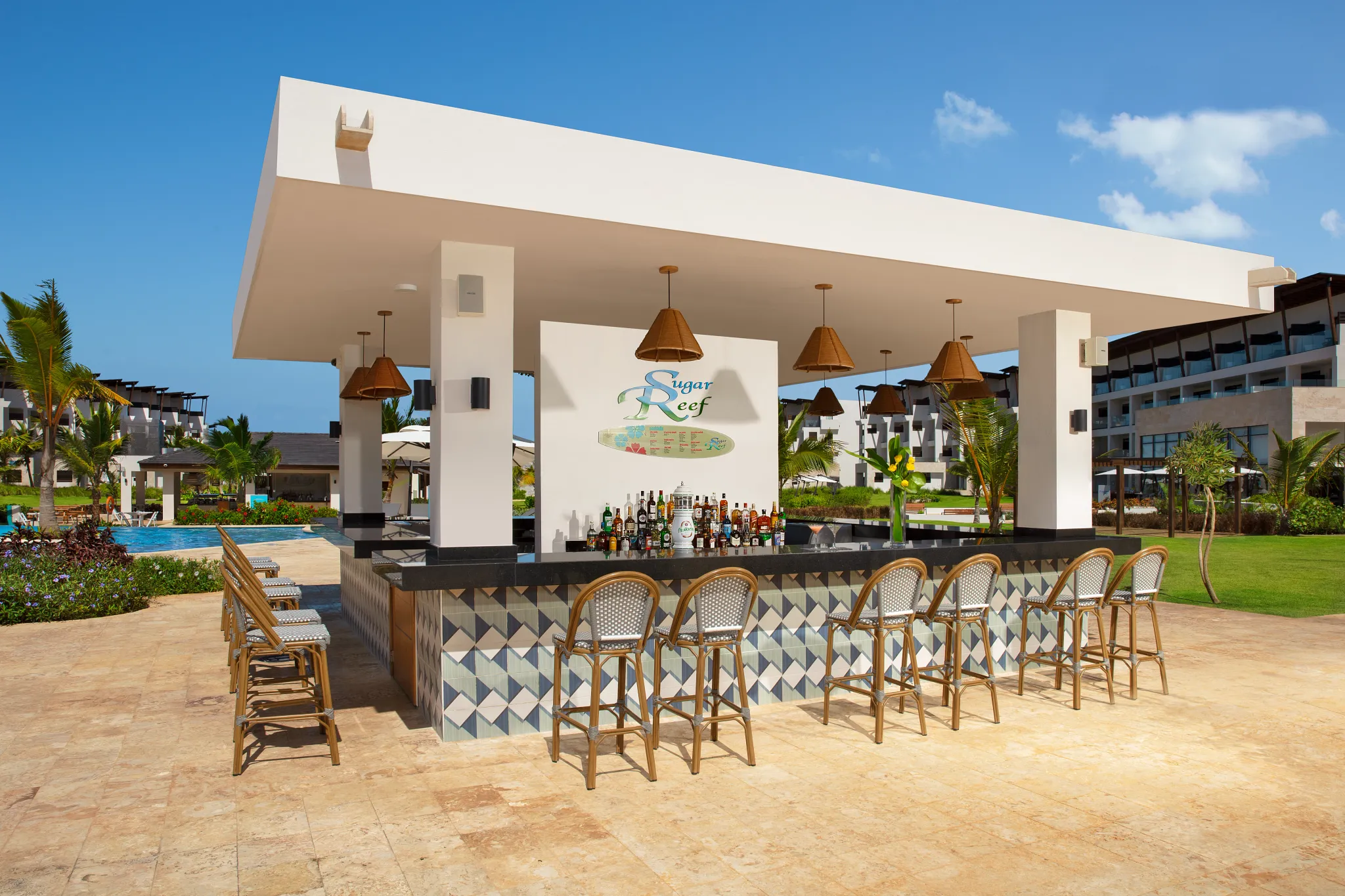 Sugar Reef bar at Dreams Macao Beach Punta Cana featuring tropical cocktails, poolside seating, and relaxed Caribbean resort ambiance.